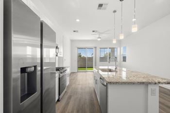 a kitchen with stainless steel appliances and a granite counter top
